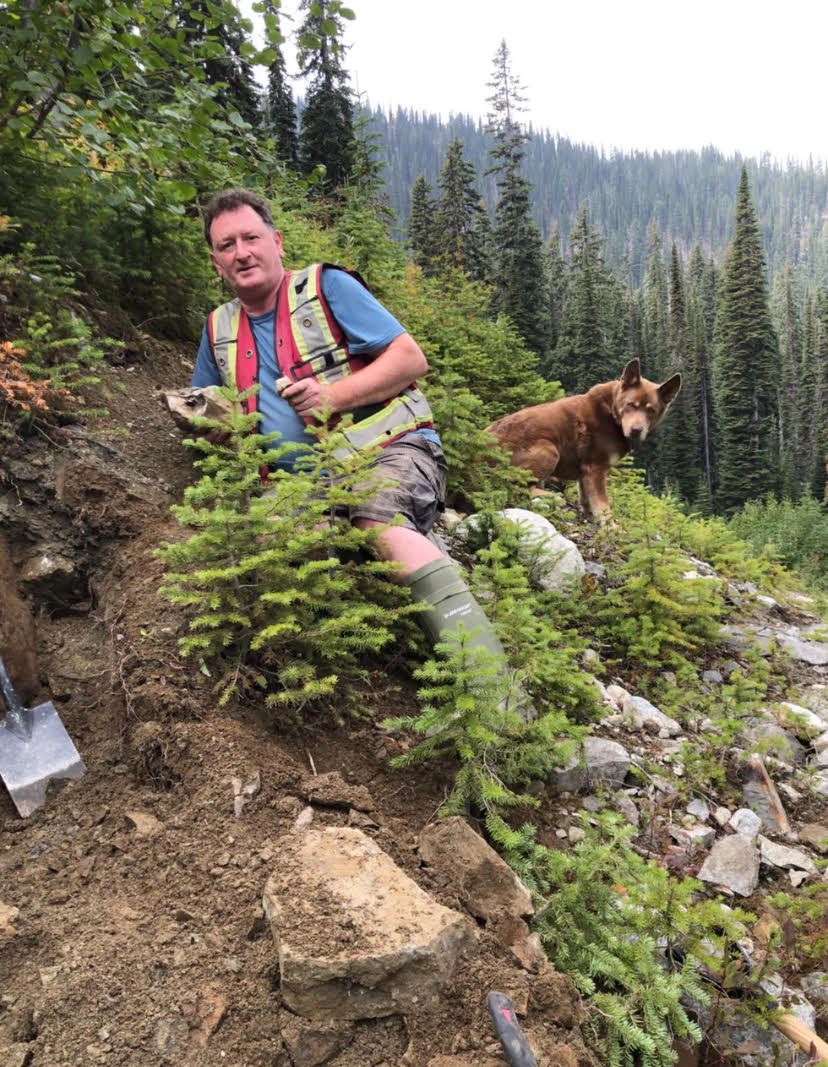 David Johnston working outdoors with a dog in the Kootenays